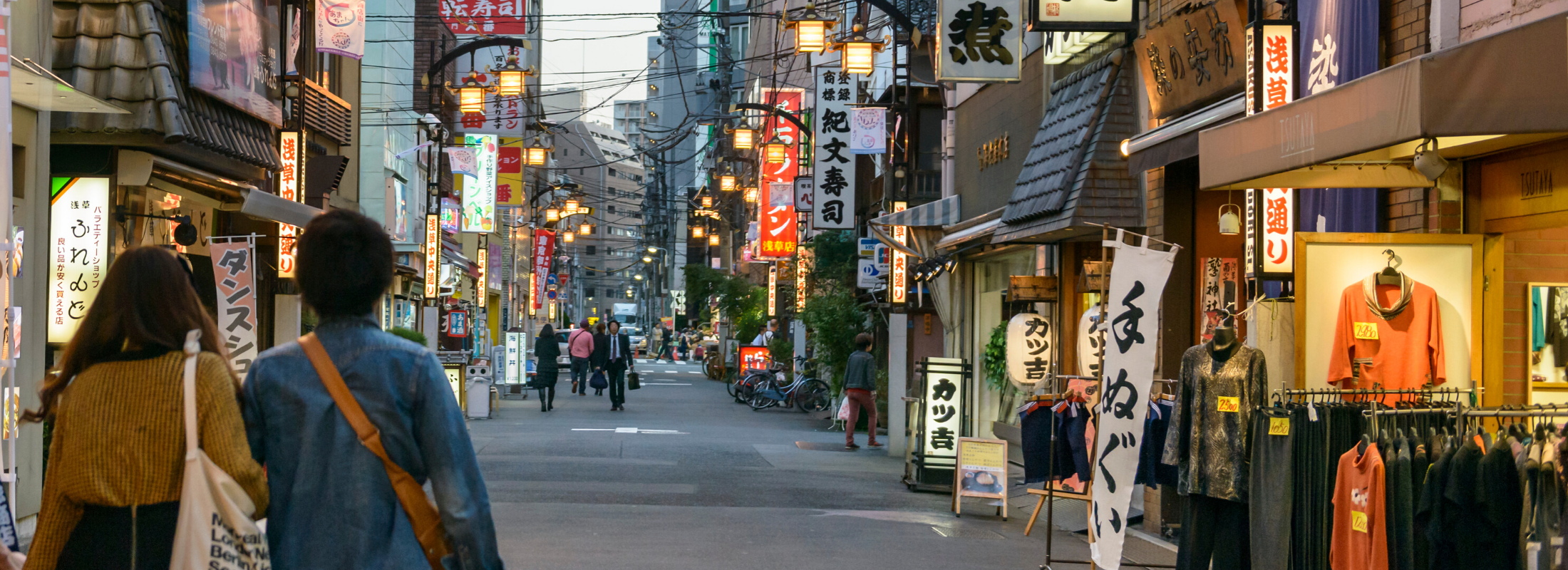 Japanese couple walking down a street in Japan